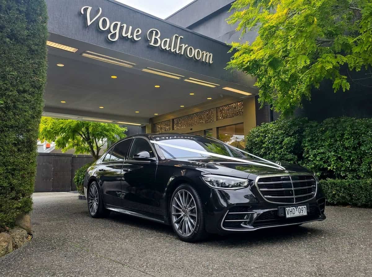 Black Mercedes-Benz S-Class wedding car with registration VHD 907 parked outside Vogue Ballroom Melbourne